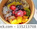 Healthy smoothie bowl topped with colorful fruits 135213708