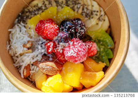Healthy smoothie bowl topped with colorful fruits 135213708