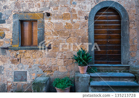 Old Wooden Door in Stone Wall Old Wooden Door in Stone Wall 135213728