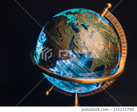 Globe with circuit board design and blue lighting displayed on a stand against a dark background Globe with circuit board design and blue lighting displayed on a stand against a dark background 135213798