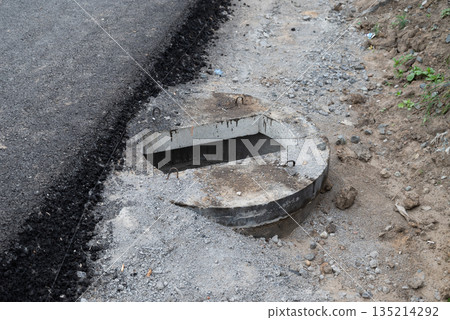 Construction of a concrete septic tank installation site in a residential area during daylight hours 135214292