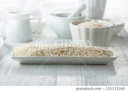 Raw organic rice in white dish. Raw organic rice in white dish. 135215268