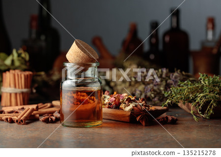 Essential herbal tincture in a small glass bottle. Essential herbal tincture in a small glass bottle. 135215278