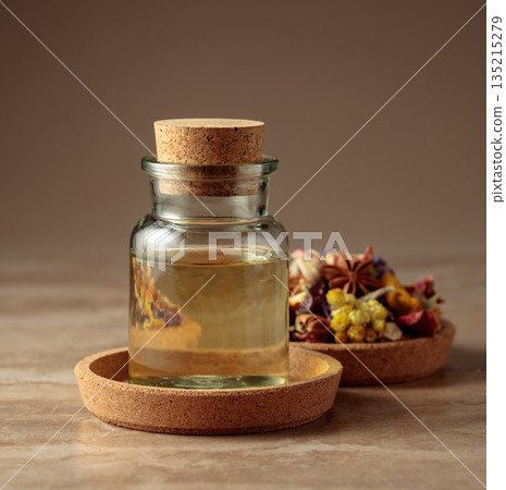 Essential oil or herbal tincture in a  small glass bottle. 135215279