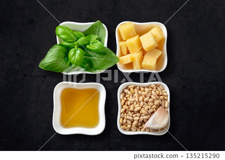 Traditional Italian pesto recipe on a black background. Traditional Italian pesto recipe on a black background. 135215290