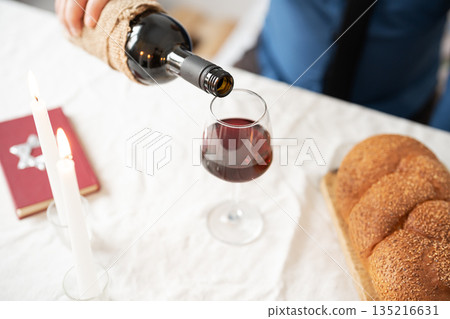 Pouring red kosher wine into glass. Shabbat Shalom concept. 135216631