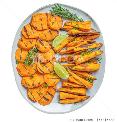Grilled sweet potato slices and wedges with herbs and lime on ceramic plate isolated on white background, top view 135216728