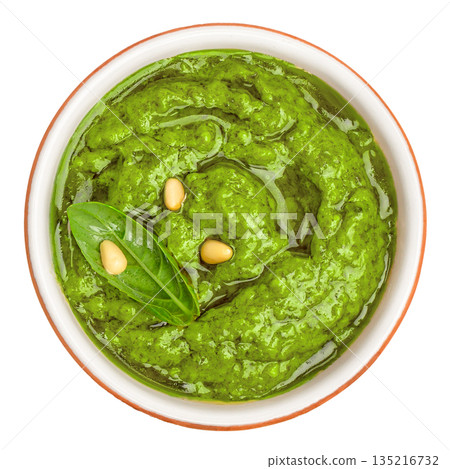 Fresh basil pesto sauce with pine nuts in ceramic bowl isolated on white background, top view Fresh basil pesto sauce with pine nuts in ceramic bowl isolated on white background, top view 135216732
