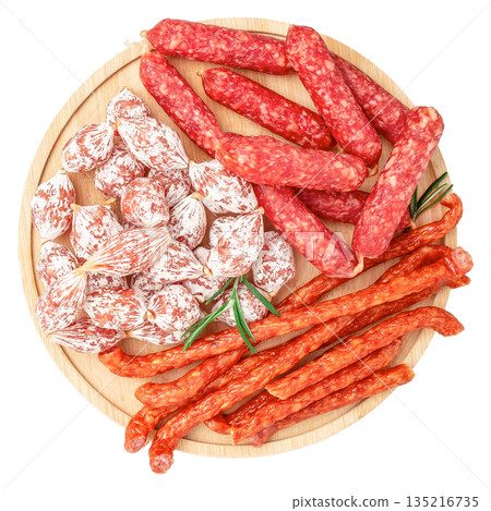 Assorted dry cured sausages on wooden board isolated on white background, top view Assorted dry cured sausages on wooden board isolated on white background, top view 135216735