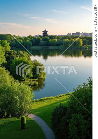 Ancient architectural scenery surrounded by green trees on the lakeside 135216897