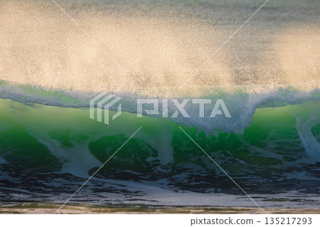 Crashing surfing wave with sunset sunlight Crashing surfing wave with sunset sunlight 135217293