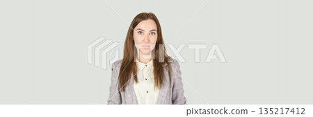 Young caucasian adult female in professional attire with neutral background Young caucasian adult female in professional attire with neutral background 135217412