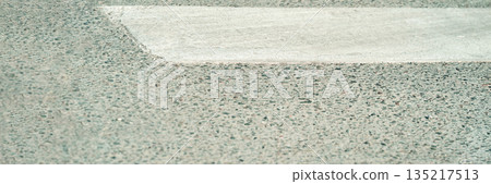 Crosswalk and pavement texture close-up in urban setting Crosswalk and pavement texture close-up in urban setting 135217513