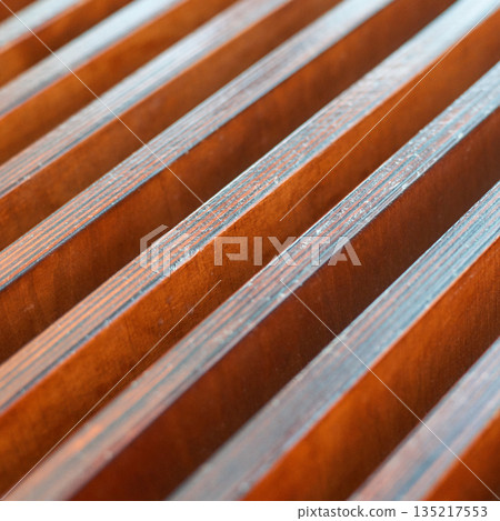 Close-up of wooden slats with brown texture and symmetrical lines creating 135217553
