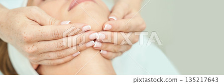 Caucasian female receiving relaxing neck massage in spa setting with soft Caucasian female receiving relaxing neck massage in spa setting with soft 135217643