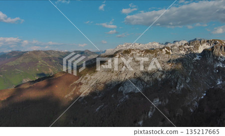 Rocky mountains and valley before sunset aerial Rocky mountains and valley before sunset aerial 135217665