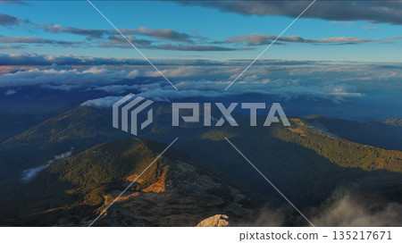 Amazing rocky mountains in clouds at sunset 135217671