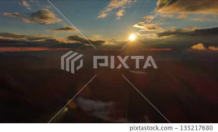 Amazing rocky mountains and sun at sunset Amazing rocky mountains and sun at sunset 135217680