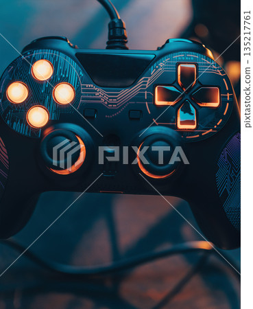 Controller sits on table as warm light shines on its buttons during a gaming session 135217761