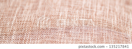 Close-up of beige textile texture with detailed weave pattern and soft natural 135217841