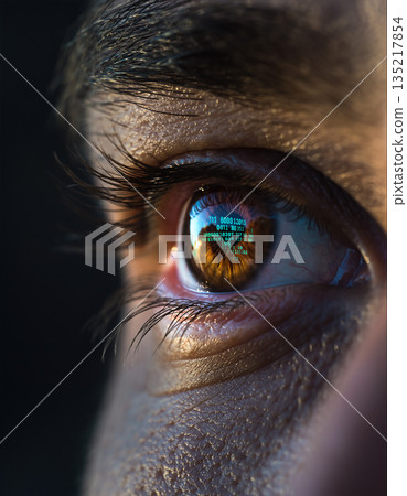 Close view of an eye showing computer code reflected on the surface during a late evening study session Close view of an eye showing computer code reflected on the surface during a late evening study session 135217854
