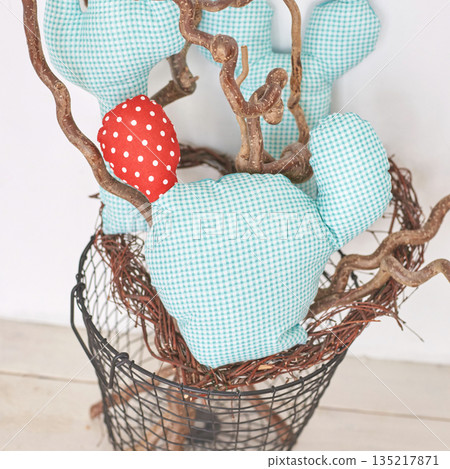 Decorative fabric cactus arrangement with red polka dot accents in wire basket 135217871
