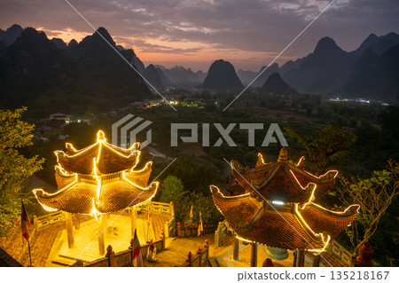 Illuminated temple overlooking Cao Bang valley at dusk in Vietnam 135218167