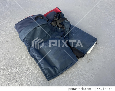 hockey pants on the gray background hockey pants on the gray background 135218258