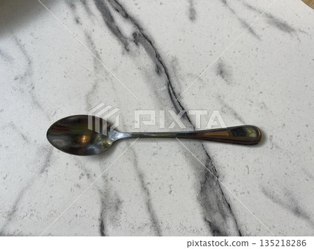 tea spoon isolated on marble table tea spoon isolated on marble table 135218286