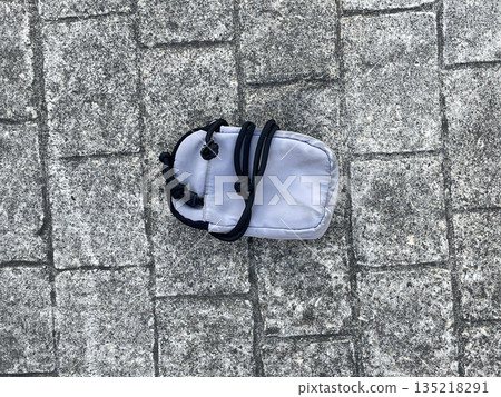 a handbag isolated on the sidewalk in the city a handbag isolated on the sidewalk in the city 135218291