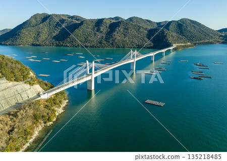 Aerial view of Bizen Hinase Bridge and oyster farming rafts in the Seto Inland Sea in winter, Okayama Prefecture Aerial view of Bizen Hinase Bridge and oyster farming rafts in the Seto Inland Sea in winter, Okayama Prefecture 135218485