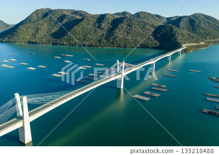 Aerial view of Bizen Hinase Bridge and oyster farming rafts in the Seto Inland Sea in winter, Okayama Prefecture Aerial view of Bizen Hinase Bridge and oyster farming rafts in the Seto Inland Sea in winter, Okayama Prefecture 135218488