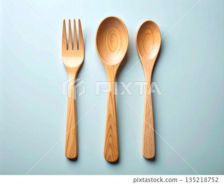 Environmental issues. Set of eco-friendly bamboo cutlery: wooden spoon, fork and knife on a white background. Environmental issues. Set of eco-friendly bamboo cutlery: wooden spoon, fork and knife on a white background. 135218752