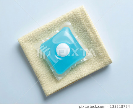 Brand friendly. Soluble laundry detergent capsule on a neutral linen cloth with empty space for text. Brand friendly. Soluble laundry detergent capsule on a neutral linen cloth with empty space for text. 135218754