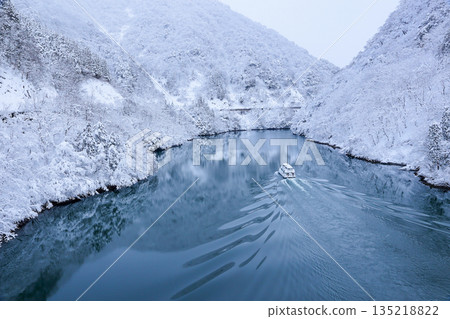 A sightseeing boat sailing down the Shogawa Gorge in winter A sightseeing boat sailing down the Shogawa Gorge in winter 135218822