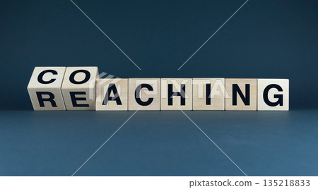 A conceptual image of wooden blocks spelling out 'coaching' and 'reaching' A conceptual image of wooden blocks spelling out 'coaching' and 'reaching' 135218833