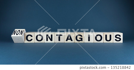 A conceptual image featuring wooden blocks spelling CONTAGIOUS and NON-CONTAGIOUS A conceptual image featuring wooden blocks spelling CONTAGIOUS and NON-CONTAGIOUS 135218842