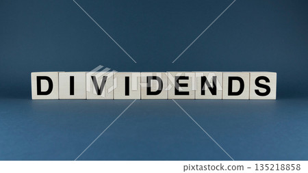 The word DIVIDENDS is spelled out on wooden blocks 135218858