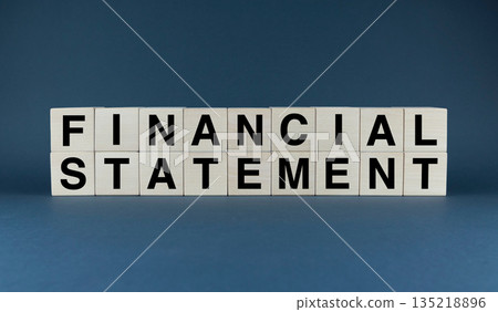 The phrase 'FINANCIAL STATEMENT' spelled out in wooden blocks symbolizes the backbone of business reporting 135218896