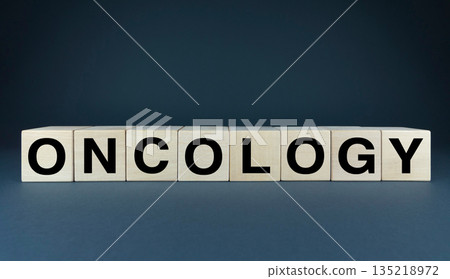 A minimalist conceptual image featuring wooden blocks spelling out the word oncology 135218972