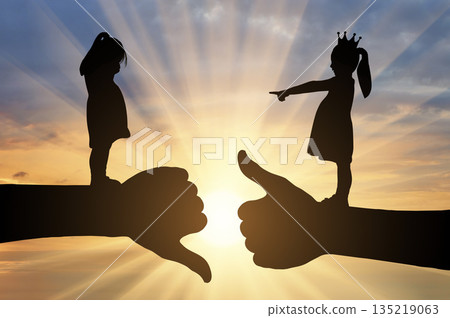 Bullying children. A girl with a crown on her head points her finger at another crying girl 135219063