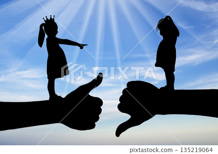 Bullying school. A girl with a crown on her head points her finger at another crying girl Bullying school. A girl with a crown on her head points her finger at another crying girl 135219064