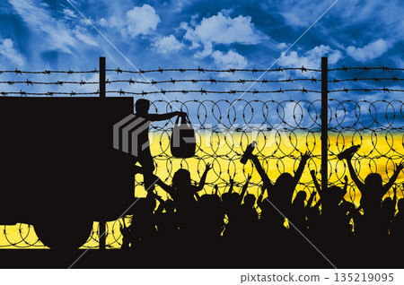 Humanitarian aid to Ukraine. Silhouette of a military man distributing humanitarian aid to people Humanitarian aid to Ukraine. Silhouette of a military man distributing humanitarian aid to people 135219095