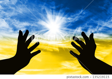 Silhouette of hands turned to the sky with a prayer for Ukraine Silhouette of hands turned to the sky with a prayer for Ukraine 135219115