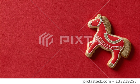 Red horse-shaped cookie on vibrant red background for festive Chinese New Year celebration Red horse-shaped cookie on vibrant red background for festive Chinese New Year celebration 135219255