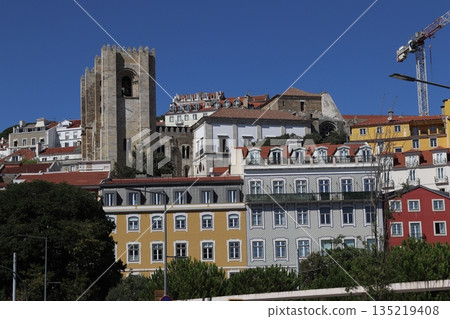 The historic Lisbon Cathedral and colorful traditional buildings in Alfama, Portugal The historic Lisbon Cathedral and colorful traditional buildings in Alfama, Portugal 135219408
