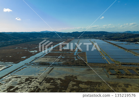 Winter in Ushimado, Okayama Prefecture: Aerial view of the Setouchi Kirei Solar Power Plant, one of Japan's largest solar power plants, located on the former Kinkai salt fields 135219576