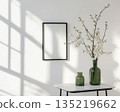Minimal interior with wall mirror and vase of blossom branches 135219662