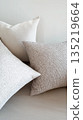 Neutral throw pillows with textured fabric in modern interior 135219664