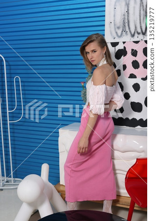 Model showcasing confidence with artistic background elements Model showcasing confidence with artistic background elements 135219777